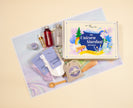 Unicorn Stardust Adventure children’s potion kit arranged with ingredients, story cards, and illustrated map