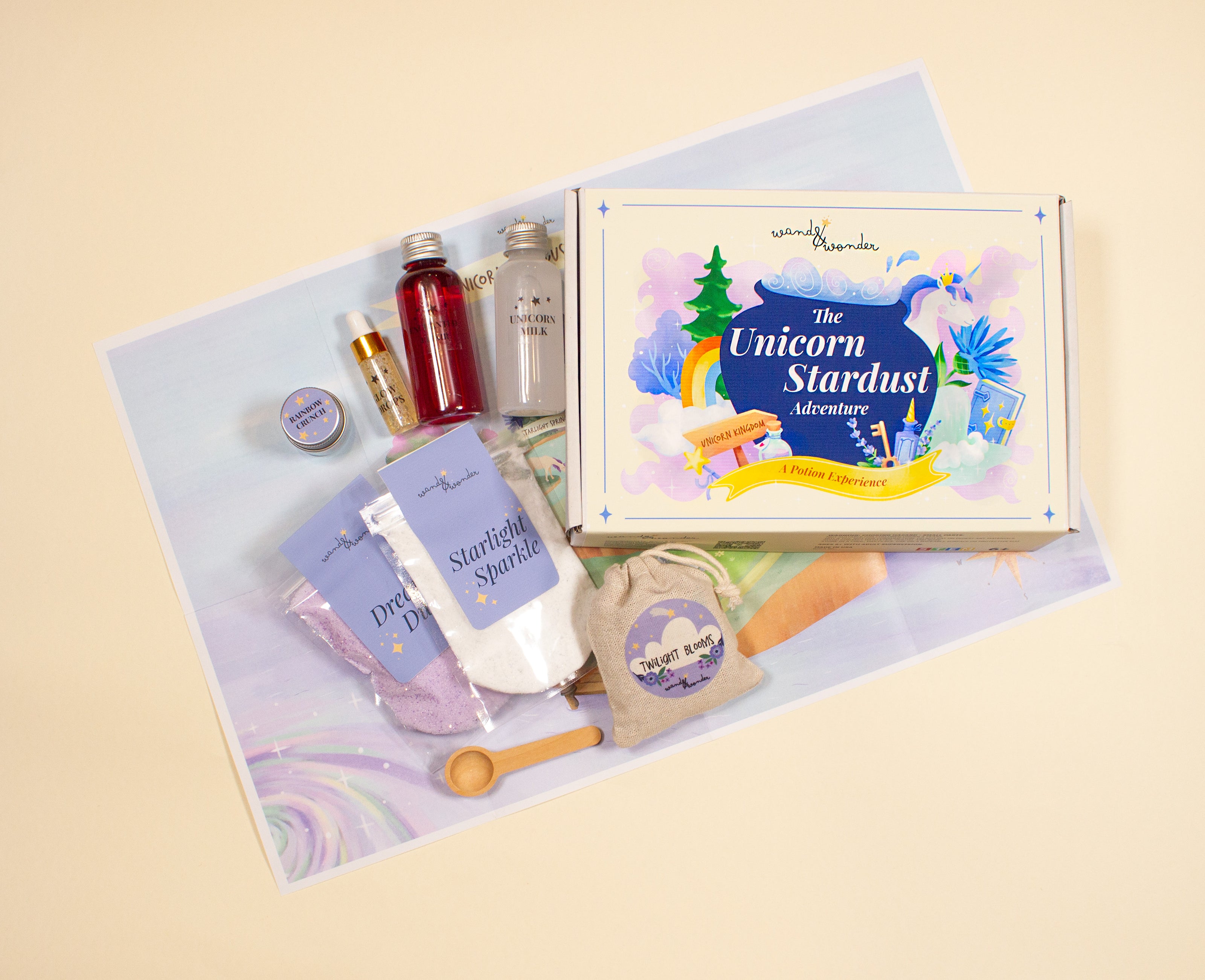 Unicorn Stardust Adventure children’s potion kit arranged with ingredients, story cards, and illustrated map